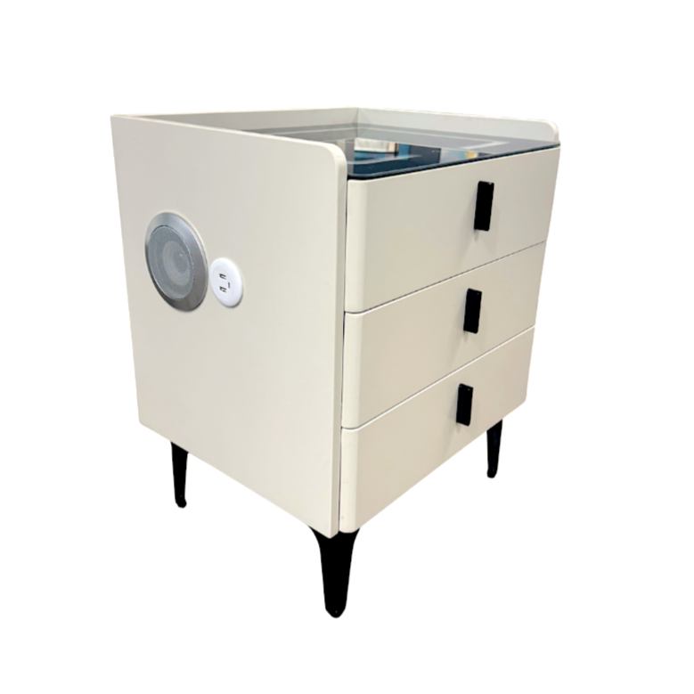 Beige cabinet with drawers and a speaker on a white background