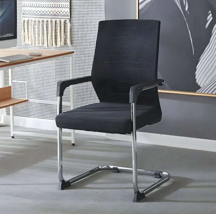 Black office chair in a modern office setting with a desk and wall art.