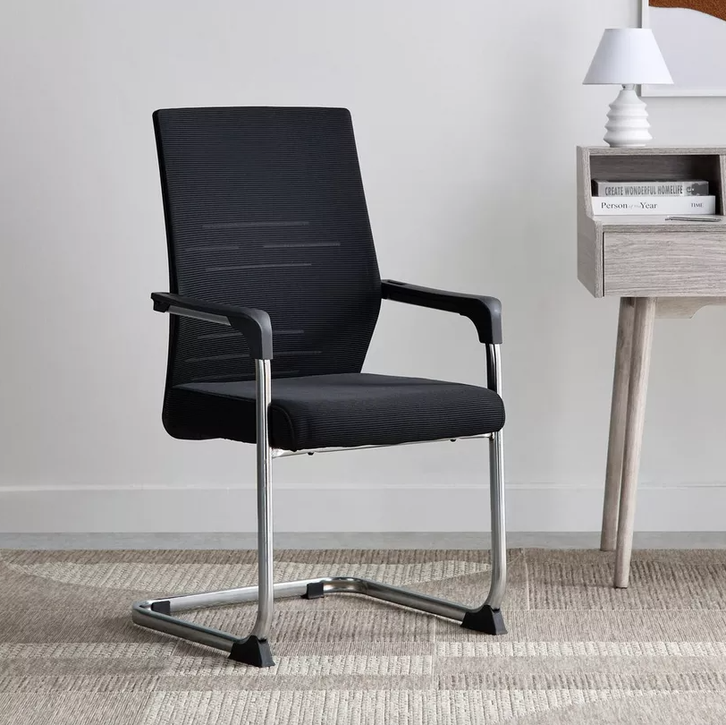 Black office chair with chrome legs in a room setting.