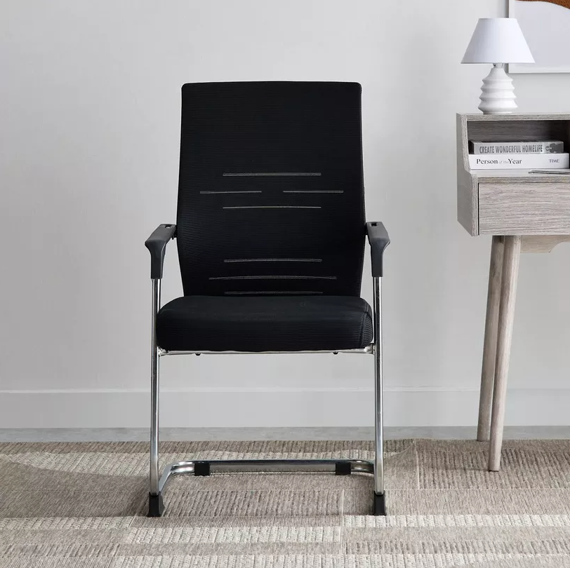 Black office chair with chrome legs in a room setting.