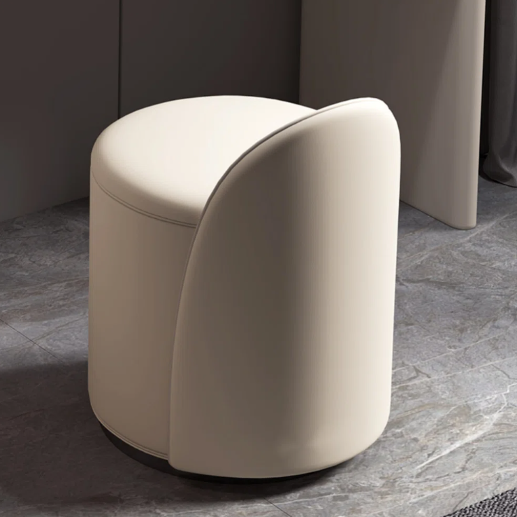 Beige cushioned stool on a marble floor with a neutral background