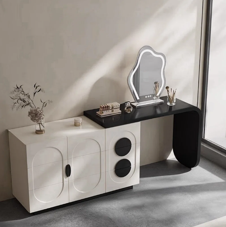 Modern vanity table with mirror and decorative items in a minimalistic room.