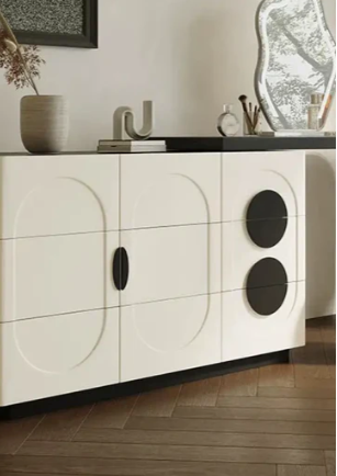 Modern black and white sideboard in a room with decor elements.