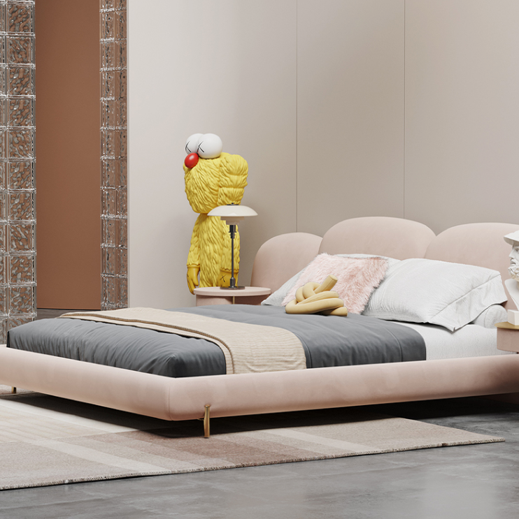 Modern bedroom with a pink bed, decorative lamp, and colorful pillows.