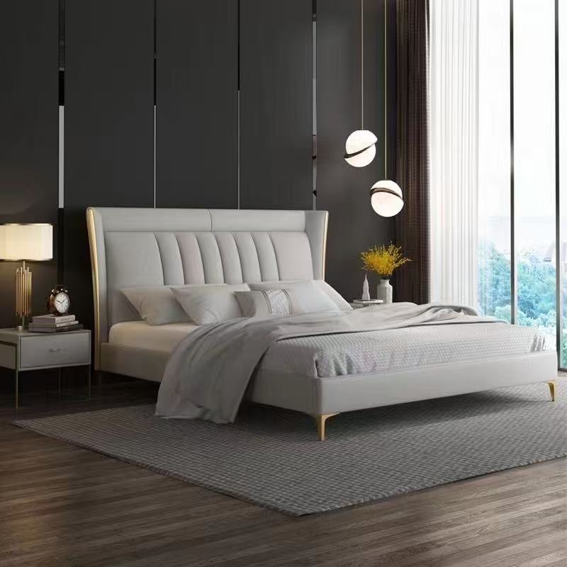 Modern bedroom with a gray upholstered bed, nightstands, and decorative elements.