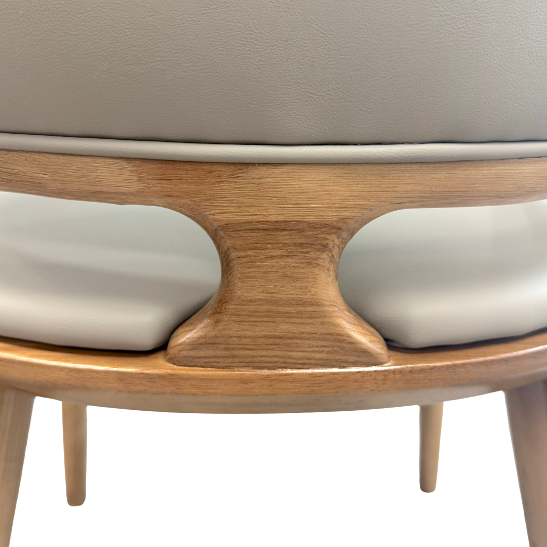 Close-up of a wooden chair with beige cushioned seat and backrest on a white background