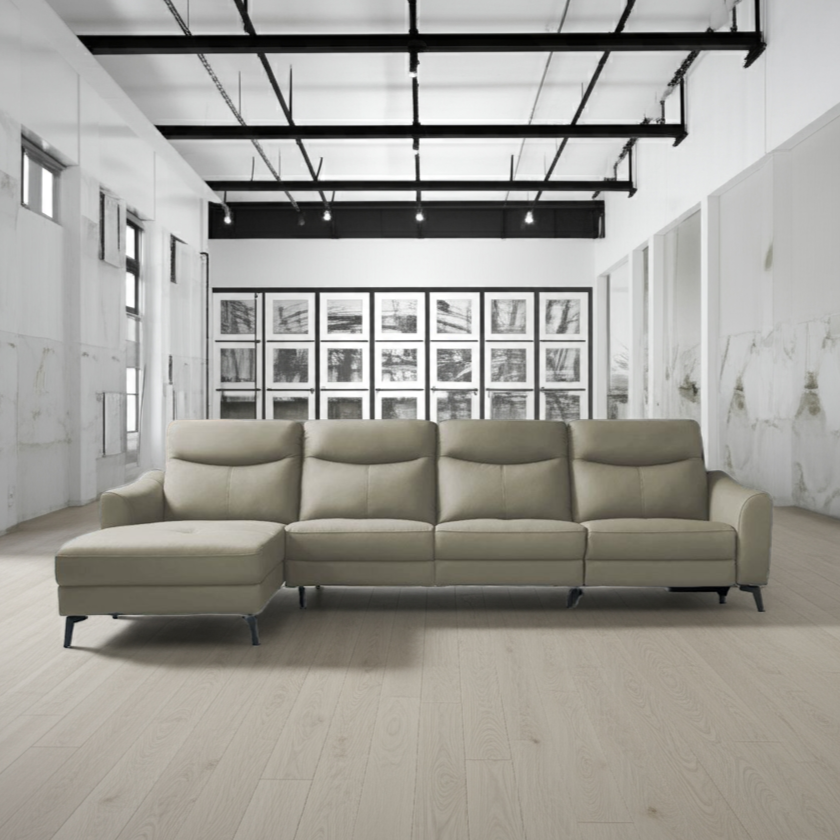 Beige sectional sofa in a modern room with white walls and wooden floor.