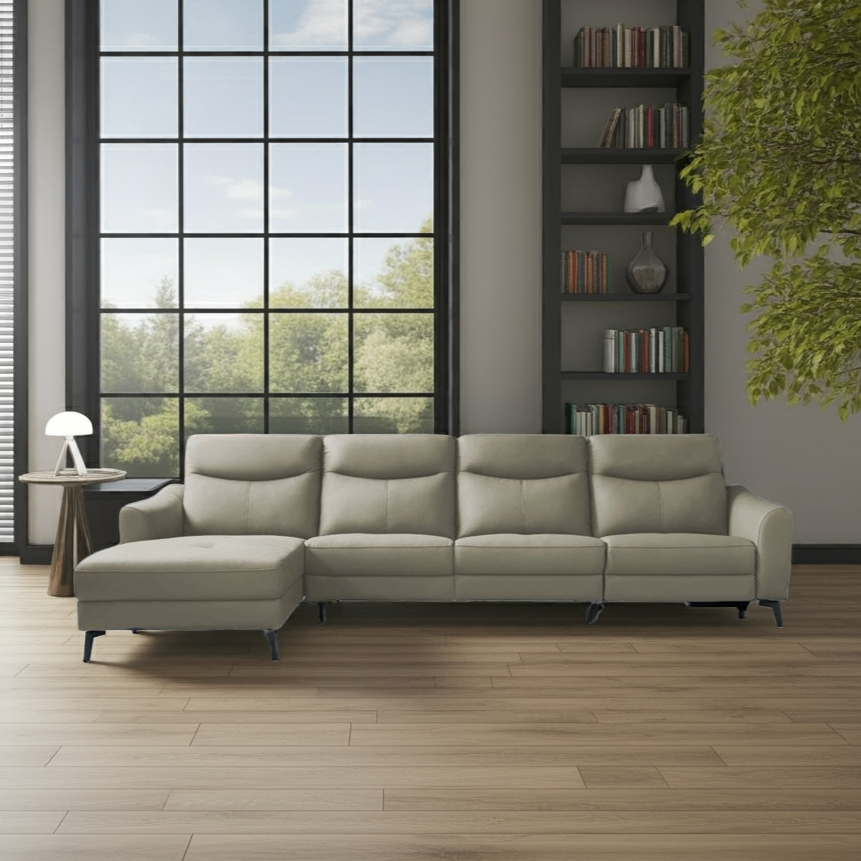 Beige sectional sofa in a modern living room with large windows and bookshelf.