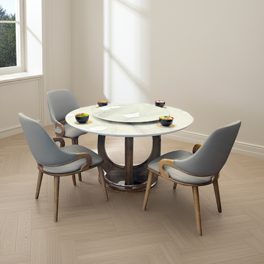 Dining room with a round table and four gray chairs on a wooden floor.