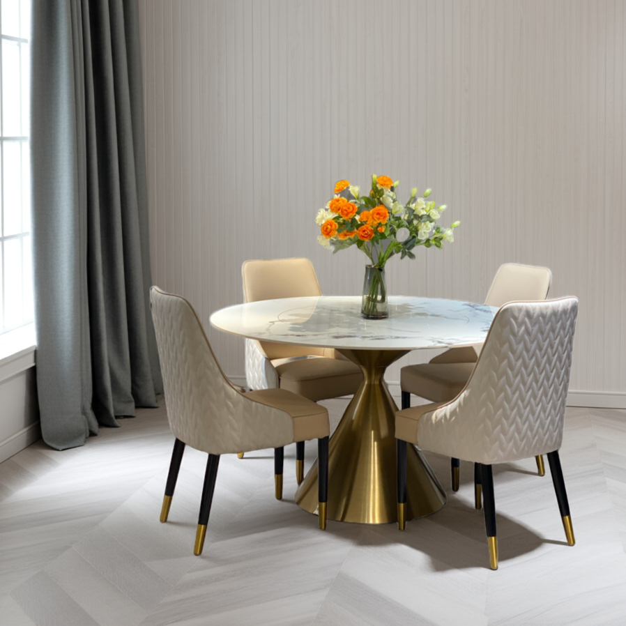 Dining room with a round marble table and gold base, surrounded by four chairs.