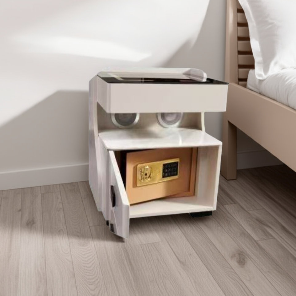 White nightstand with a built-in safe compartment next to a bed.