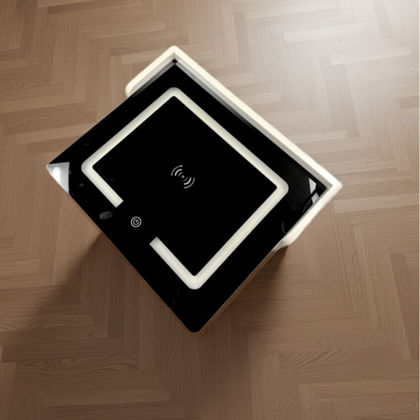 Black rectangular device with a screen on a wooden floor