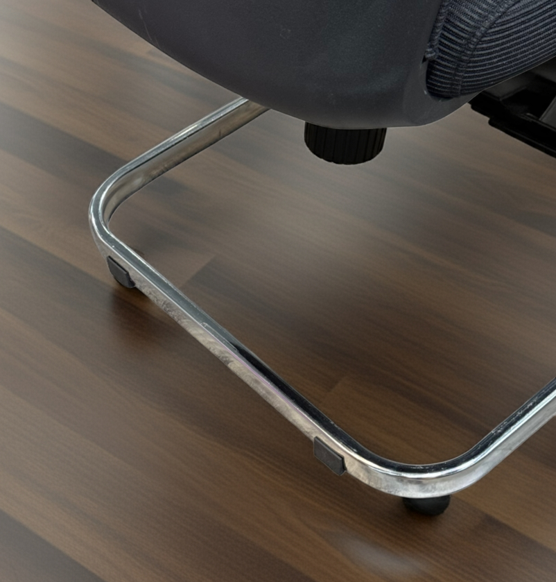 Close-up of a chair leg on a wooden floor