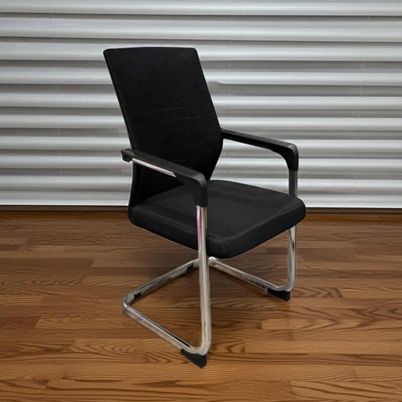 Black office chair on a wooden floor with a metal shutter background