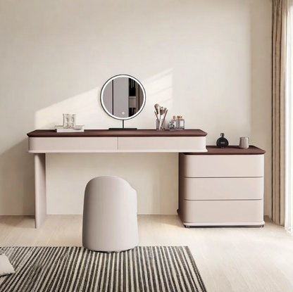 Modern vanity table with round mirror and decorative items in a minimalistic room.