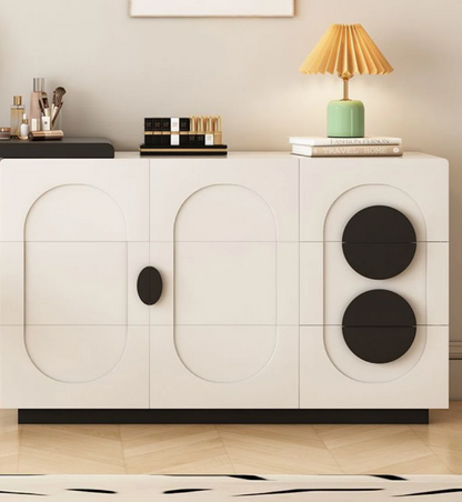 Modern white sideboard with black circular designs on a neutral background