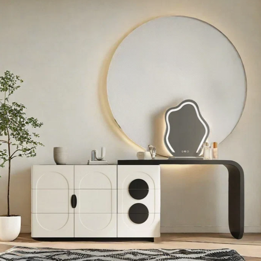 Modern interior with a round mirror, white cabinet, and decorative items.