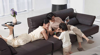 Family of three relaxing on a brown sectional sofa in a modern living room genesis furniture