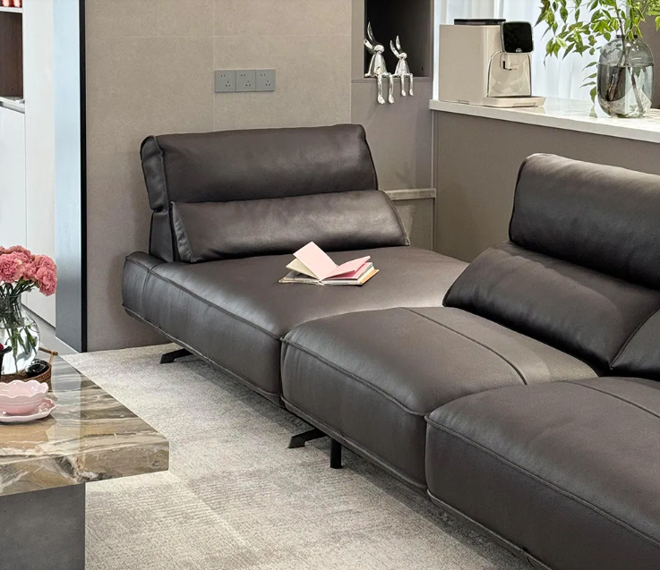 black sectional sofa in a living room setting with a coffee table and decorative items genesis furniture