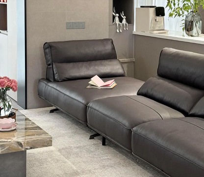 black sectional sofa in a living room setting with a coffee table and decorative items genesis furniture