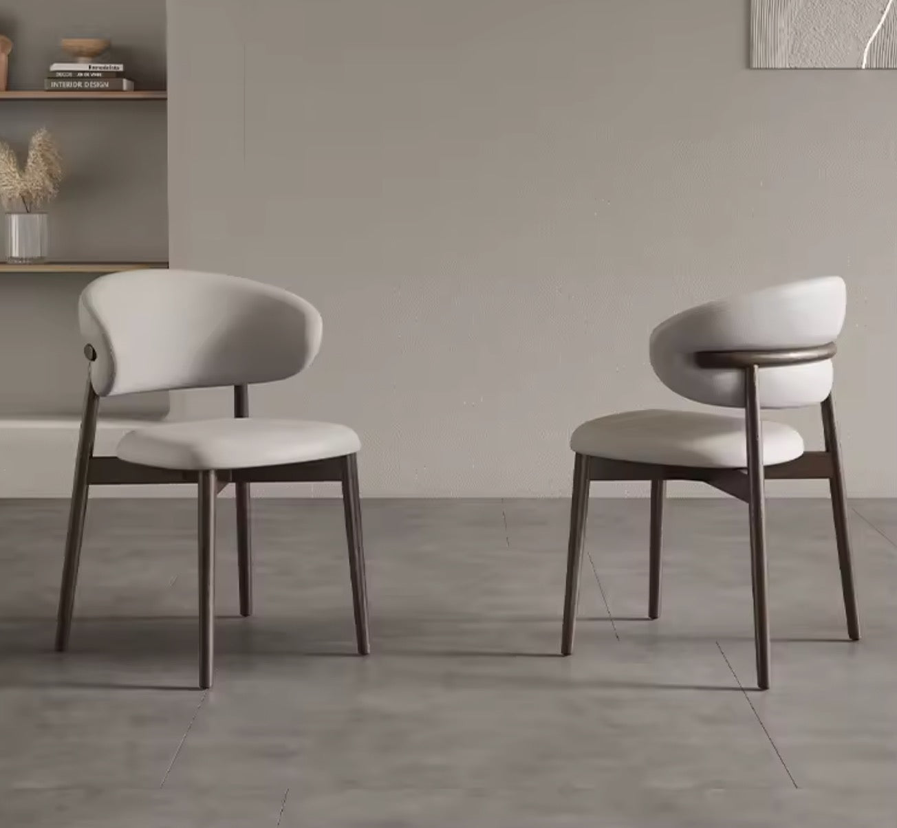 Two modern chairs with white seats and dark wooden legs in a minimalistic room.