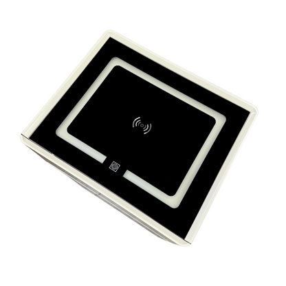 Square electronic device with a wireless charging pad on a white background