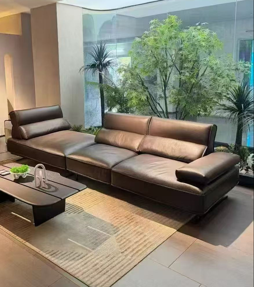 Modern brown leather sectional sofa in a living room with a coffee table and decorative items genesis furniture