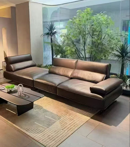 Modern brown leather sectional sofa in a living room with a coffee table and decorative items genesis furniture