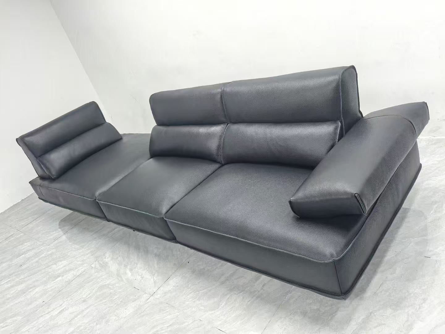 Gray sectional sofa on a white floor with a white wall background genesis furniture