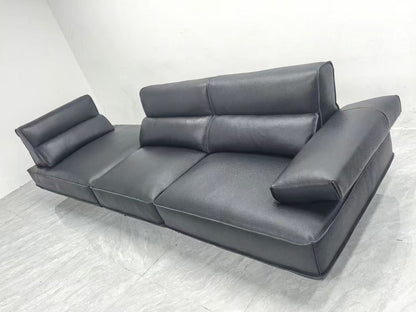 Gray sectional sofa on a white floor with a white wall background genesis furniture