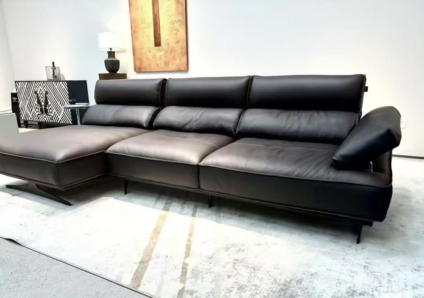 Modern black leather sectional sofa in a living room setting genesis furniture