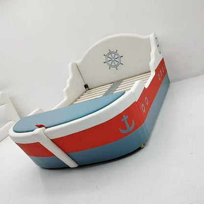 Children's boat-shaped bed with red and blue design on a white background
