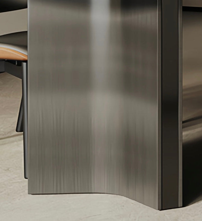 Metallic dining table corner with a chair partially visible