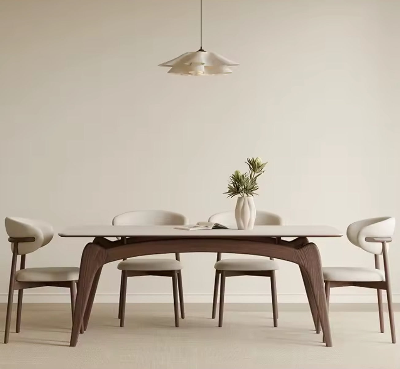 Dining room with a wooden table and chairs against a plain wall.