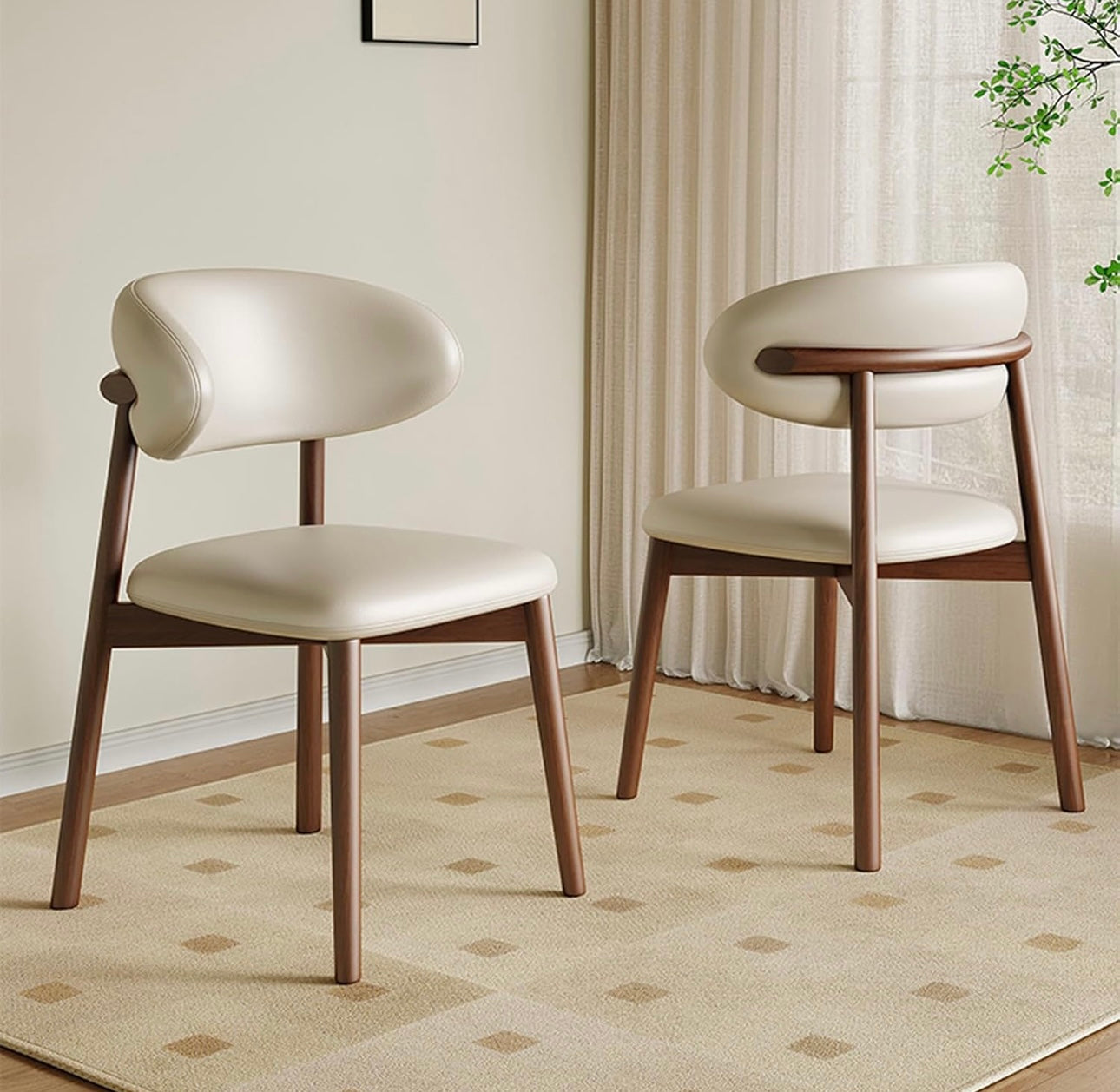 Two wooden chairs with white cushioned seats on a patterned rug.