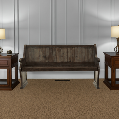 Wooden bench in a room with two matching side tables and lamps.