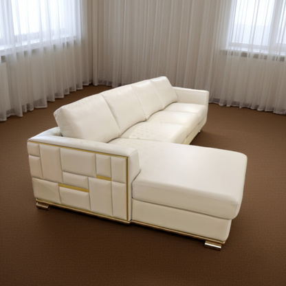 White sectional sofa in a room with brown carpet and white curtains.