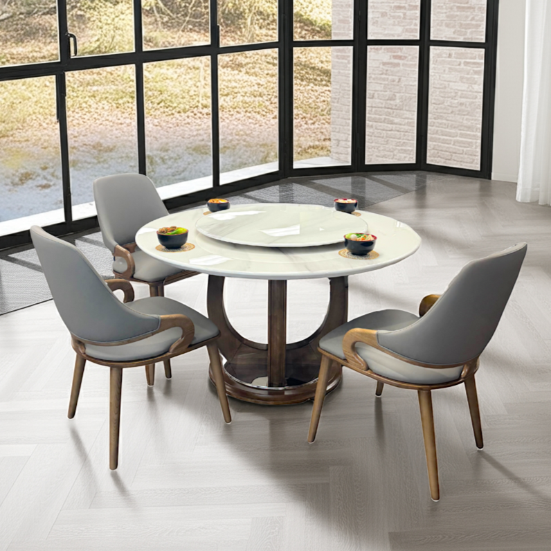 Dining table with chairs in a modern room with large windows.