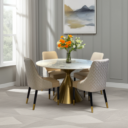 Dining room with a round table and chairs, featuring a vase of flowers on the table.