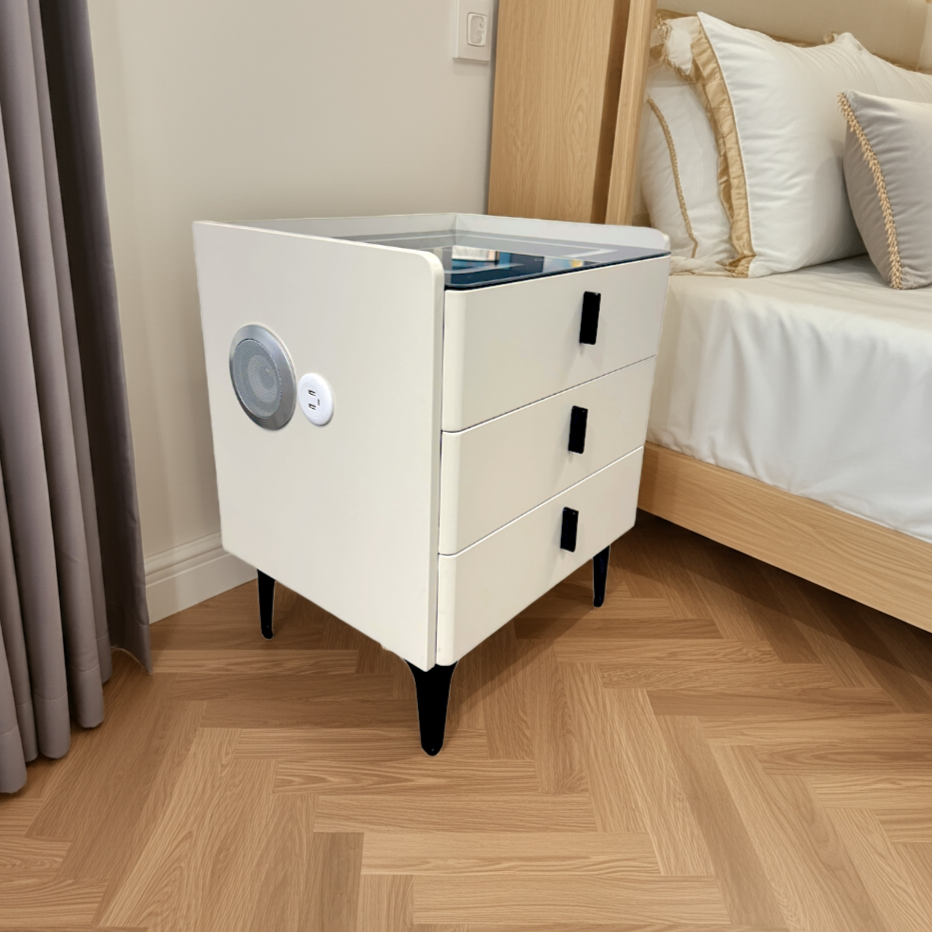 White nightstand with three drawers in a bedroom setting