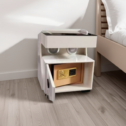 White nightstand with a built-in safe compartment next to a bed.