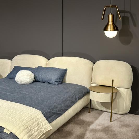 Modern bedroom with beige bed, side table, and pendant lights against a dark wall.