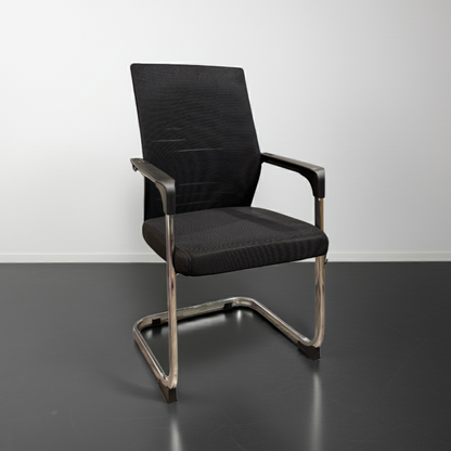 Black office chair with metal frame on a gray floor and white wall