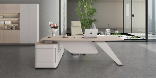 Modern office desk with a laptop, plants, and decor in a stylish office setting.