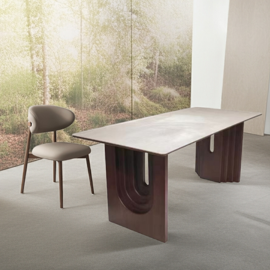 Modern dining table with unique design in a room with a window view of trees.