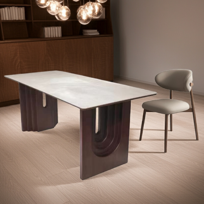 Modern dining table with a chair in a dimly lit room with a chandelier.